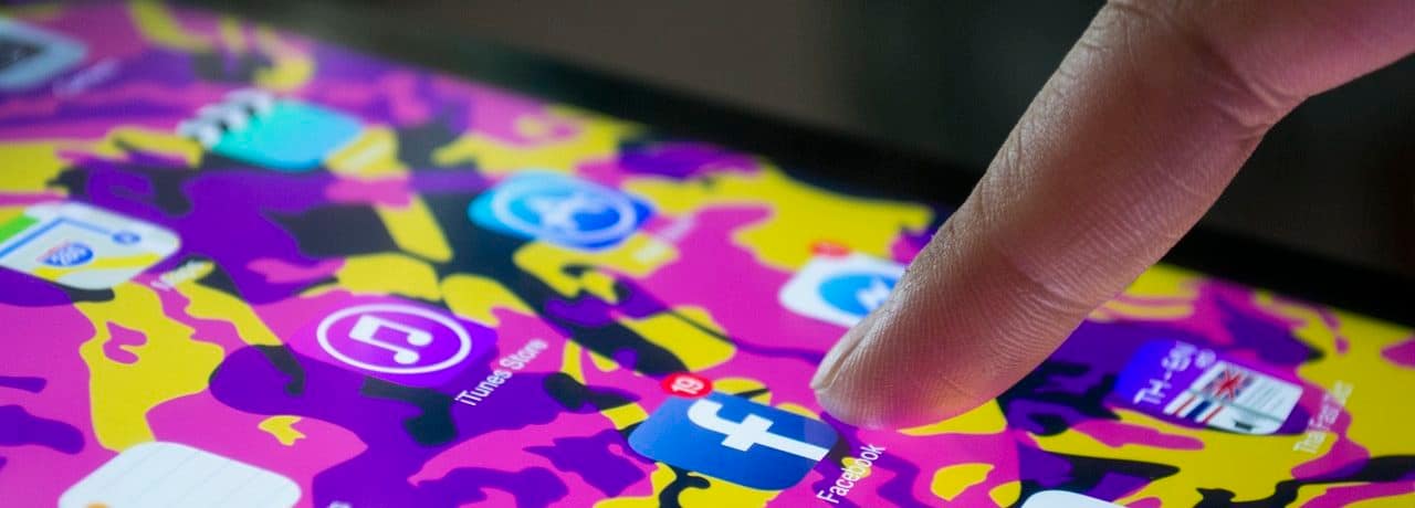 finger touching social media on a tablet